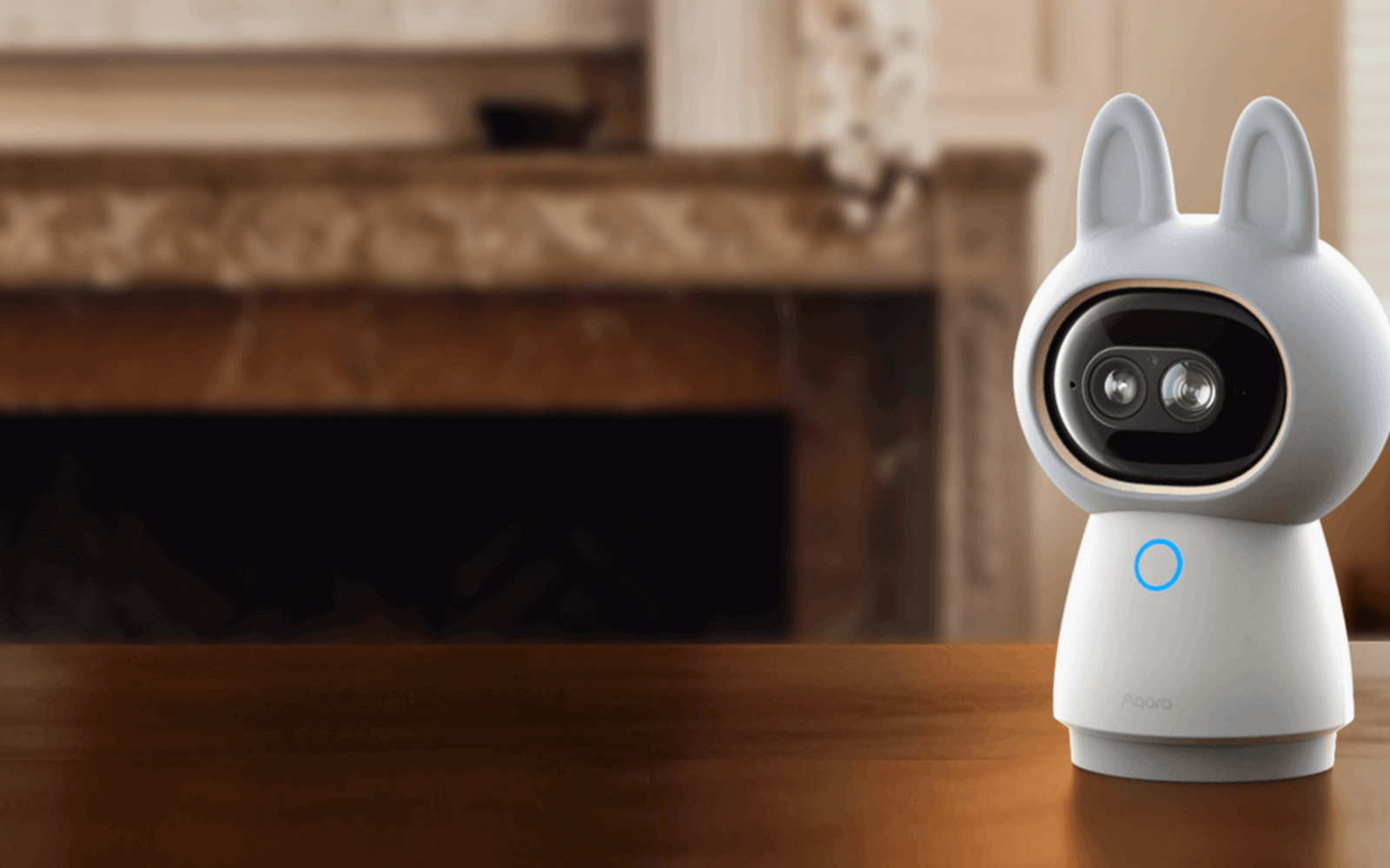 Aqara Camera Hub G350 on an oak table in a warm living room